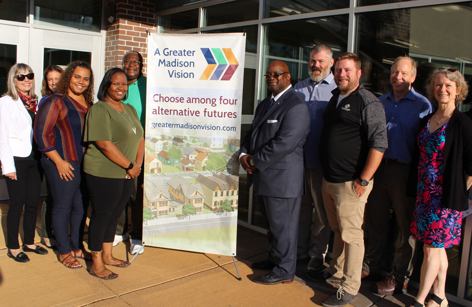 Photo of a group of people with A Greater Madison Vision sign