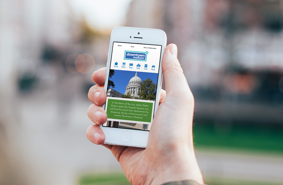 Photo of Madison's Central Business Improvement District website on smartphone in hand outside