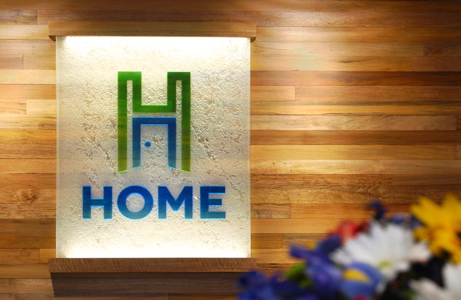 Photo of glass logo sign on Home Savings Bank wall