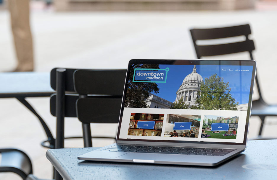 Photo of Madison's Central Business Improvement District website on laptop on table outside